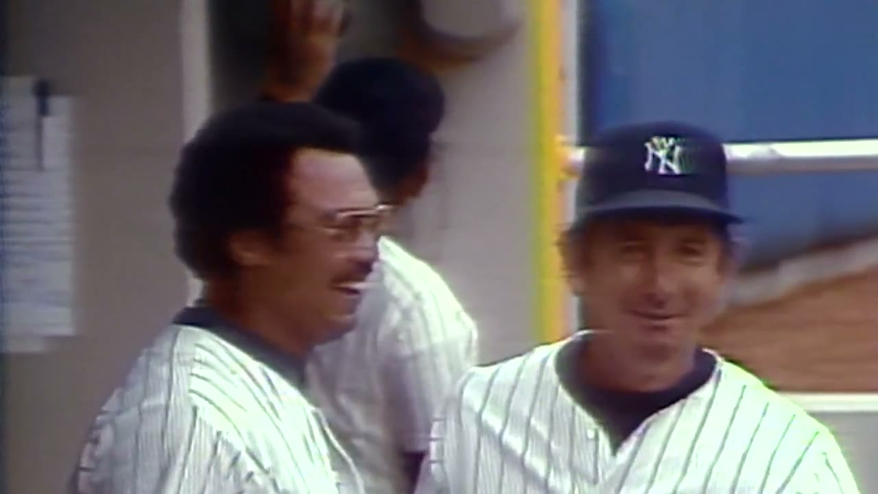 Reggie Jackson laughing in the Yankees dugout beside manager Billy Martin after his 1978 Opening Day home run
