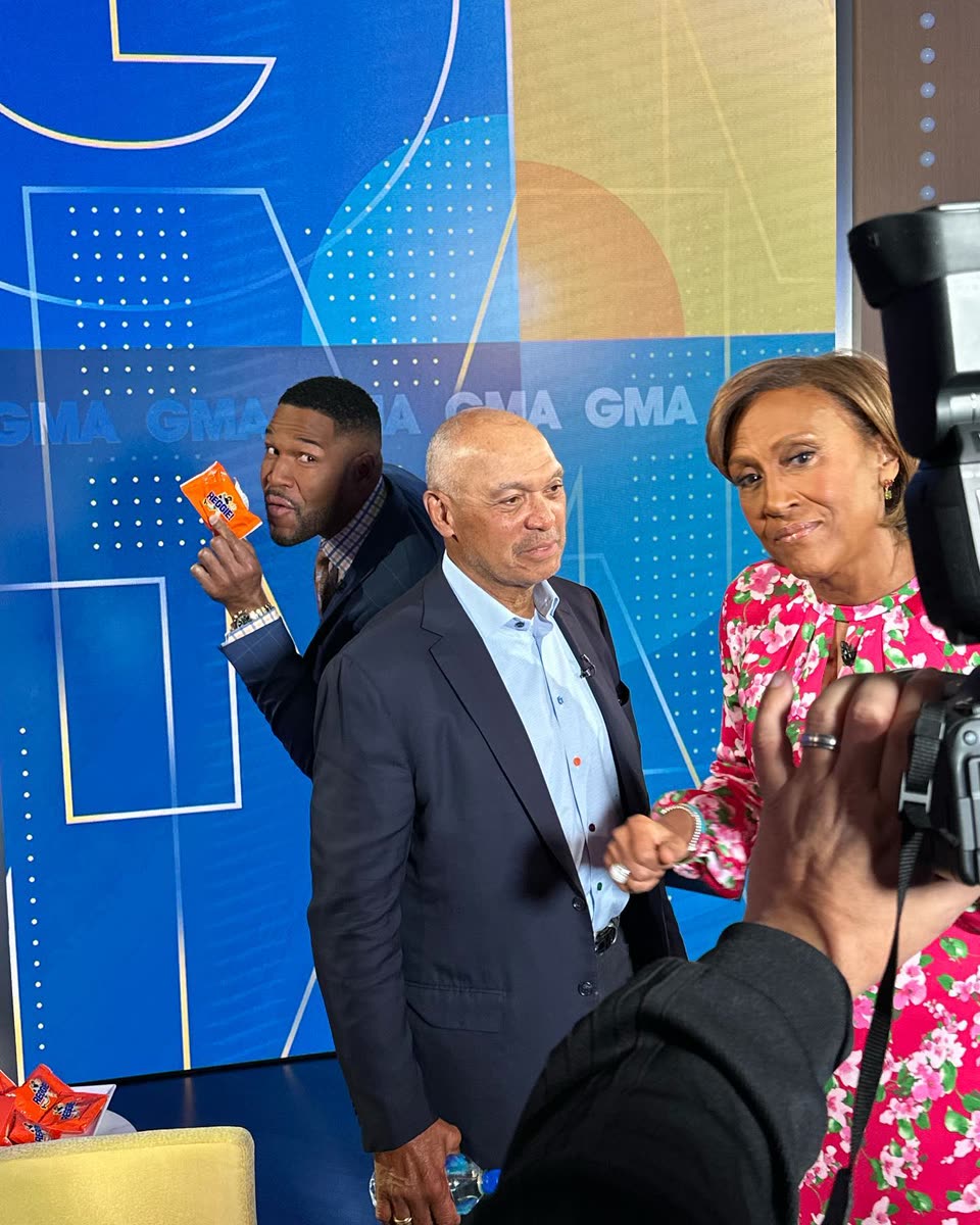 Reggie Jackson on the Good Morning America set as a host holds up a REGGIE! Bar