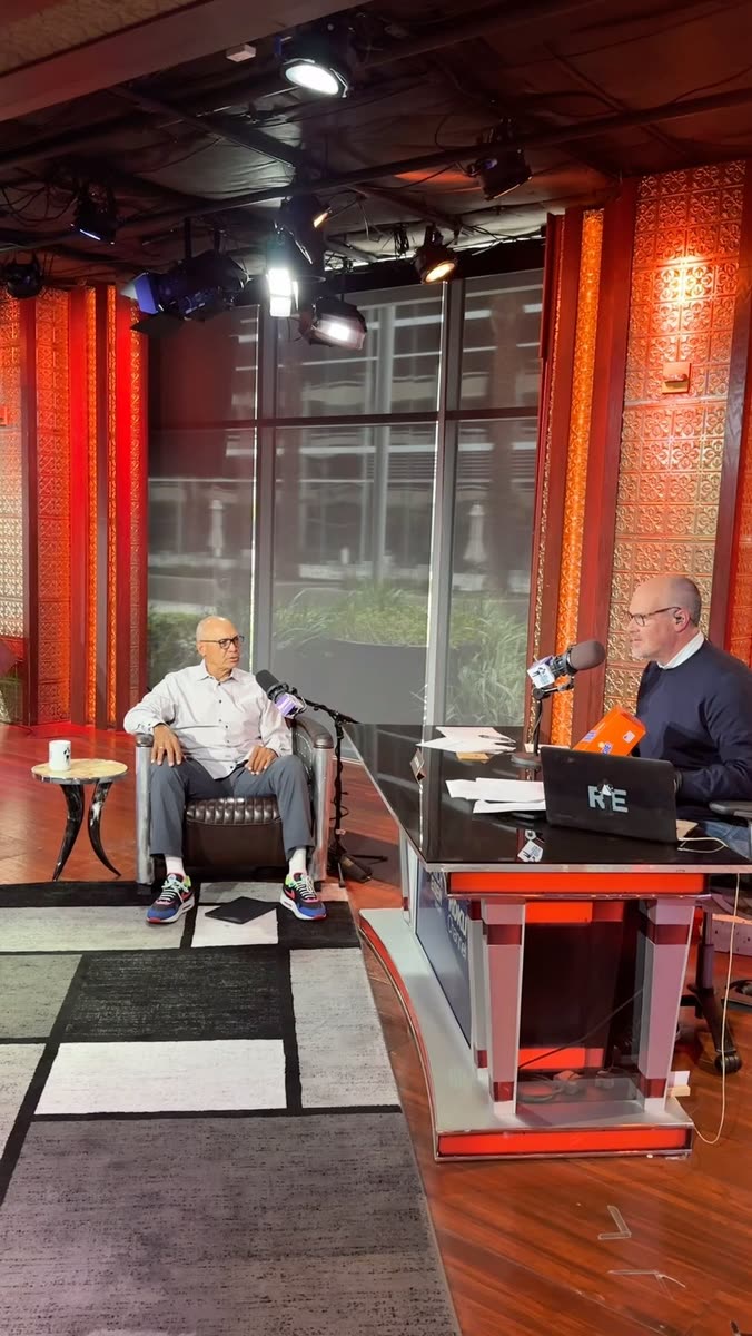Reggie Jackson being interviewed in a radio studio while the host holds an orange REGGIE! box